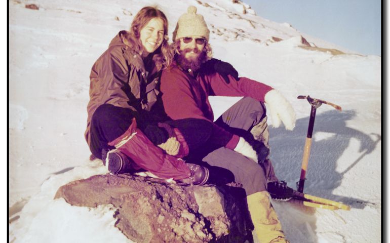 A couple sitting on rock.