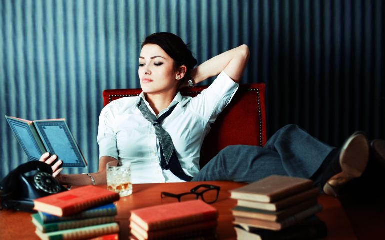 Vintage toned brunette relaxes, reading a book.