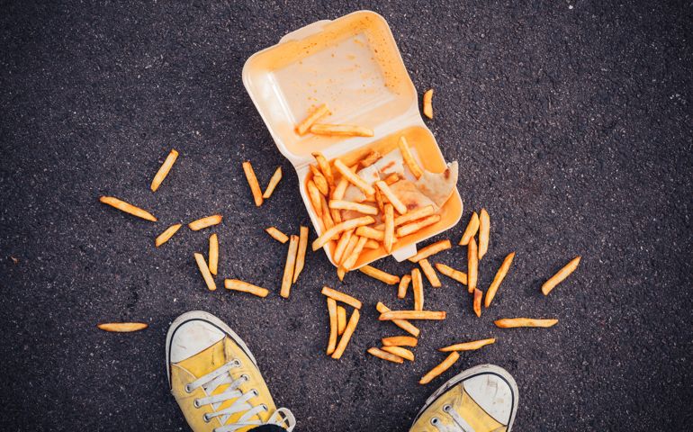 Young man has dropped his chips in the street