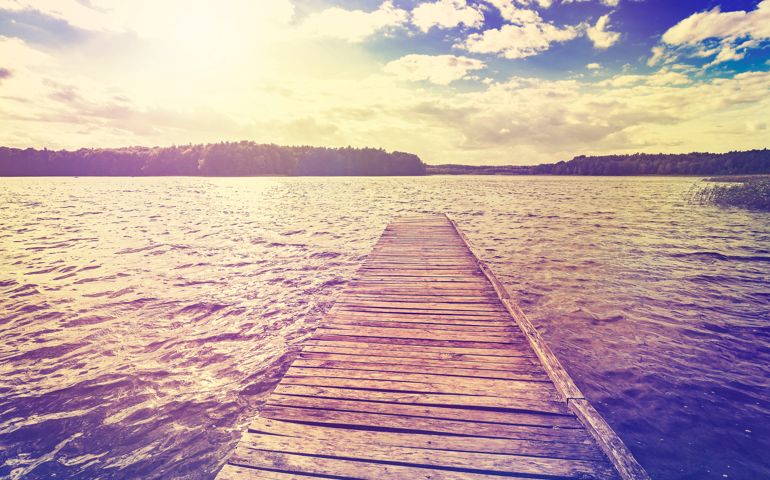 Vintage toned photo of beautiful sunset over lake, Ostromecko in Poland.