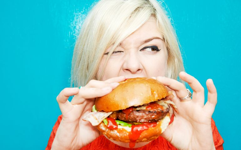 woman eating hamburger