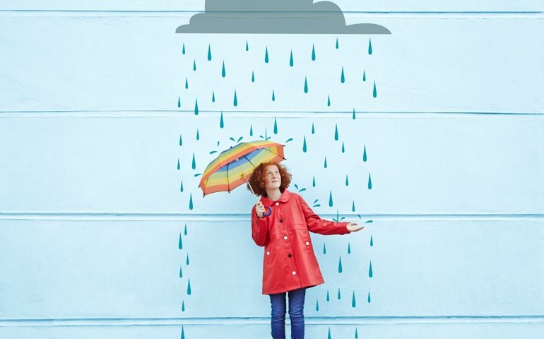Girl holding umbrella with cartoon rain cloud