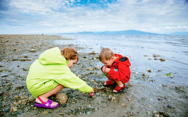 Children paying at Rathrevor Beach in Vancouver Island. Canada.