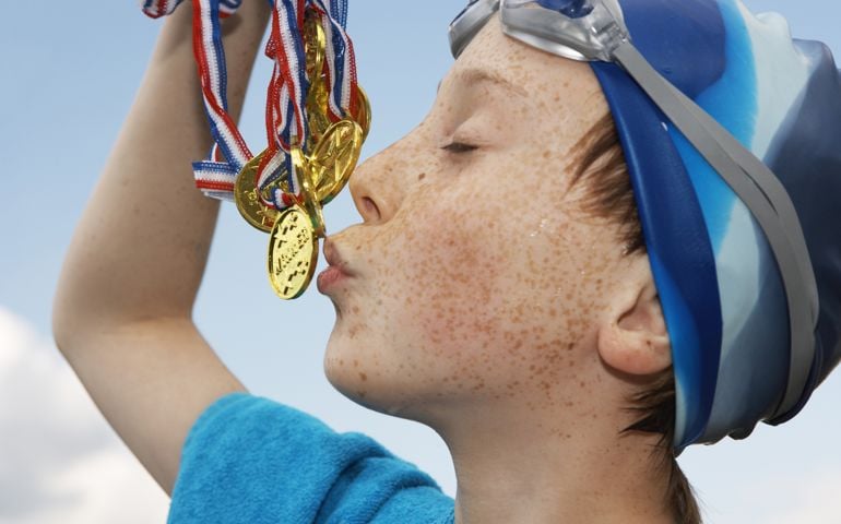 A boy wearing swimming hat and goggles