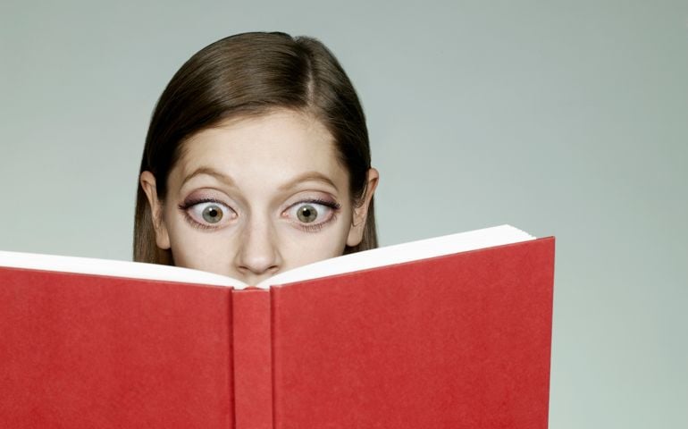 Woman with big eyes reading book