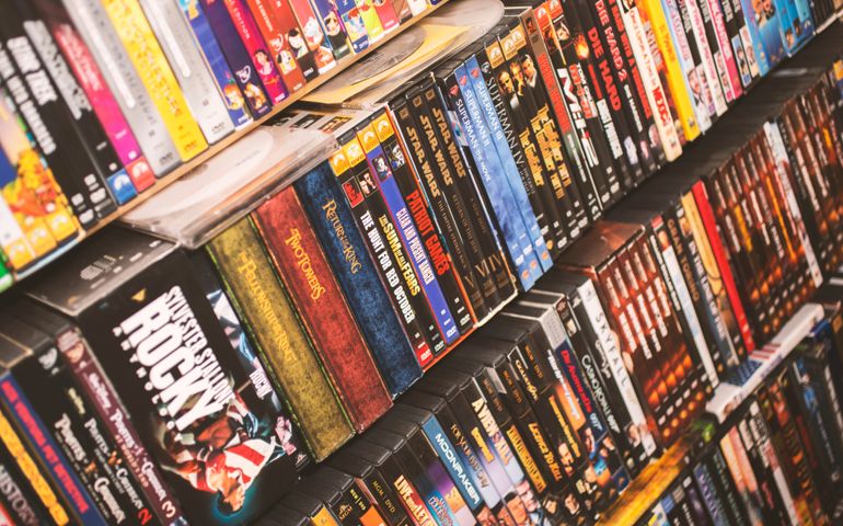 A DVD movie collection in wood shelves