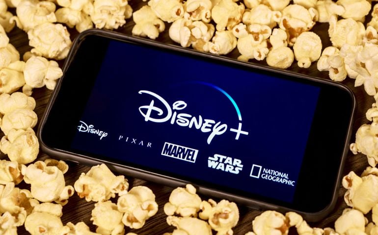 Disney Plus on smartphone with popcorn