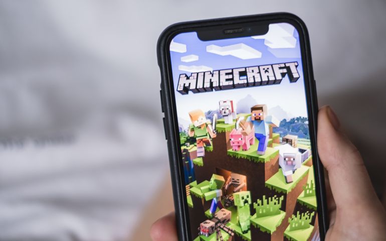 Minecraft game on the iPhone screen in hand