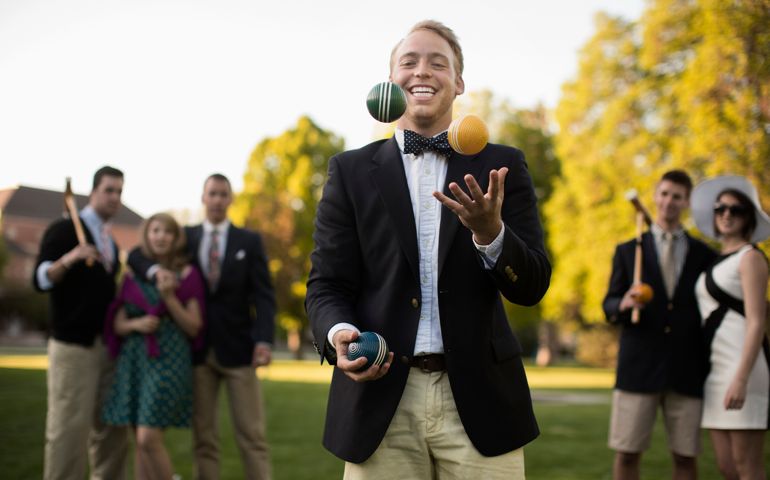 Caucasian man juggling croquet balls