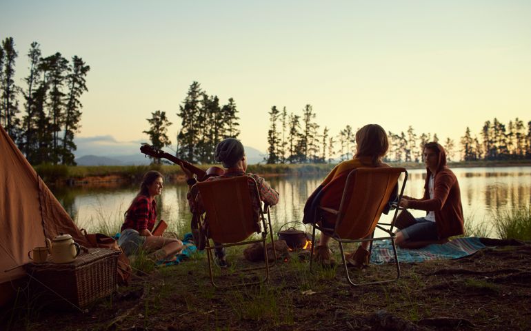 Young friends camping by lake