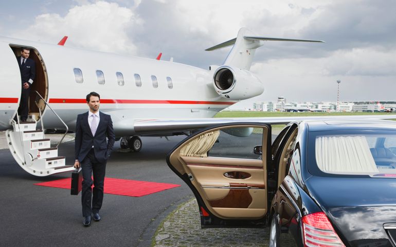 Businessman approaching car at airport