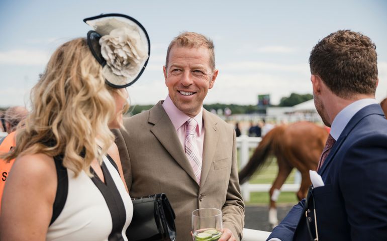 Couples enjoying a day at the races. Friends enjoying drinks at the race course.