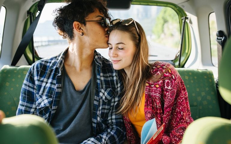 Couple of young people during trip by car