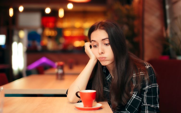 Stood up woman having a bad time alone in the restaurant