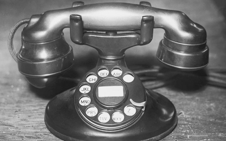 Telephone with rotary dial, close-up (B&amp;W)