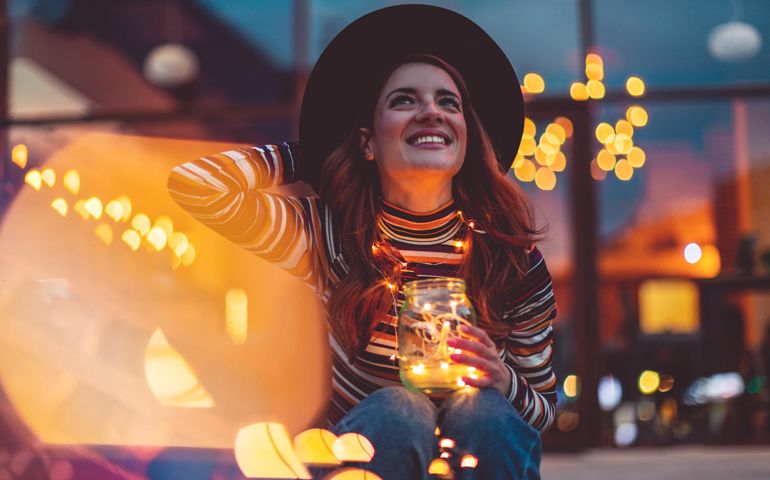 Cheerful woman with Christmas lights
