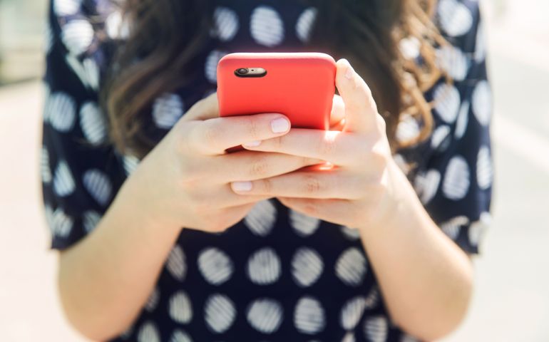 Woman using a smart phone, close up.