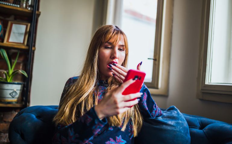 Young amazed woman receiving shocking news