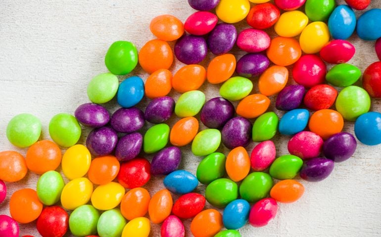 Skittles candy on the table, colorful sweet candy background, high angle view