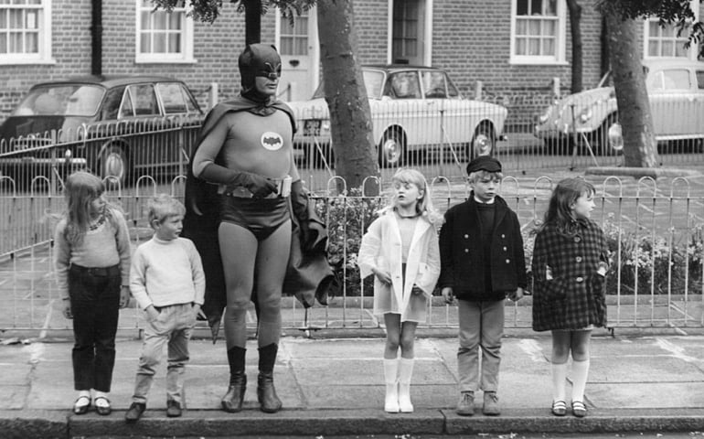 American actor Adam West, as Batman, making a road safety film with a group of child actors in Kensington, London. Original Publication: People Disc - HM0458