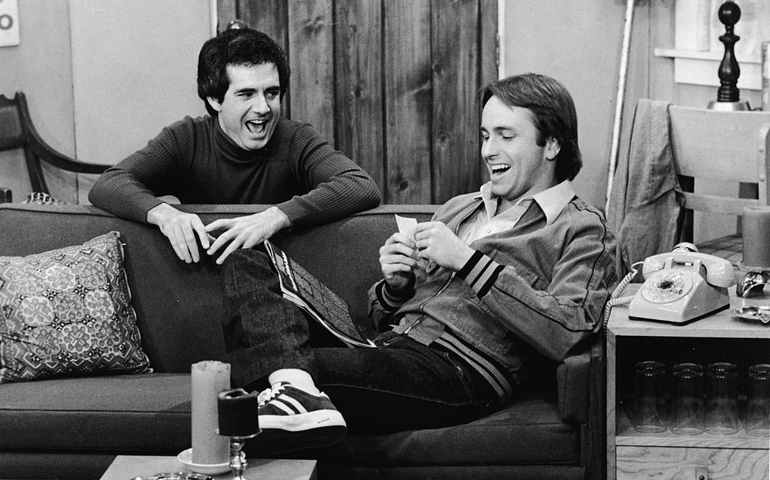 American actors John Ritter (1948 - 2003) and Richard Kline share a laugh in a still from the television series, 'Three's Company', circa 1970s.