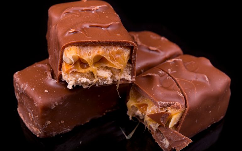 slices of Snickers bars on a black background