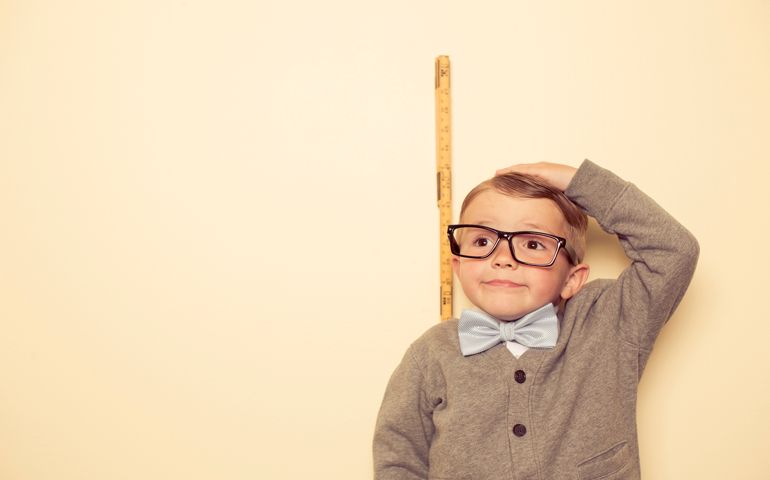 A young child wants to be taller. Big things with becoming big.