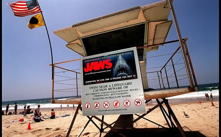 A poster advertising the anniversary collector's edition of the movie "Jaws" is posted on a lifeguard tower July 2, 2000 on Zuma Beach in Malibu, CA. The sign has led to complaints by beach goers with young children, who feel that it is inappropriate for the sign to be on display so close to the water and so near the 4th of July.