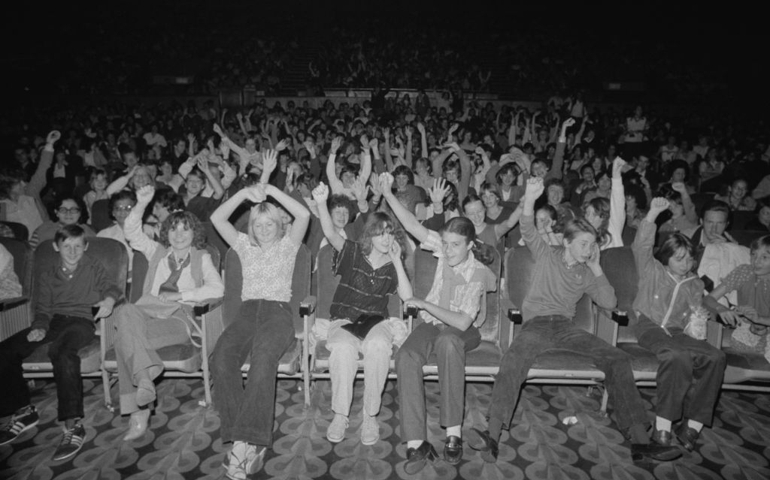 Young people sit in a cinema for the screening of American musical romantic comedy film 'Grease', UK, 11th September 1978.
