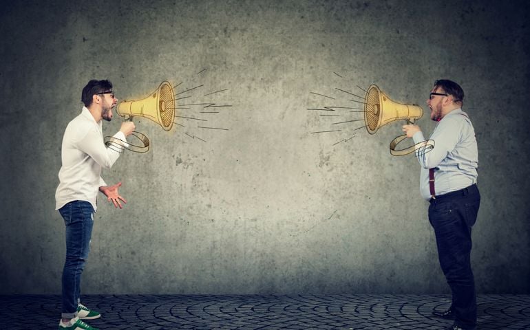 Businessmen screaming into a megaphone at each other having an angry debate