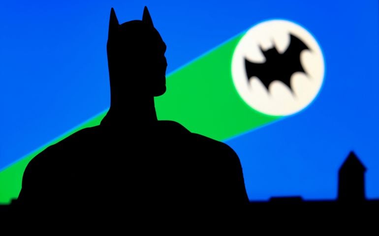 Portrait of Batman with the Bat Signal from the 1960s television series background of Gotham City