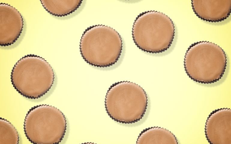 Peanut butter filled candy with chocolate frosting isolated on yellow