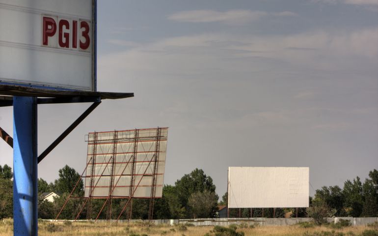 Drive in movie theater with two screens and PG13 film rating sign somewhere in the southwest.