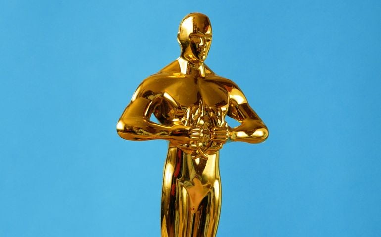 Hollywood Golden Oscar Academy award statue on blue background