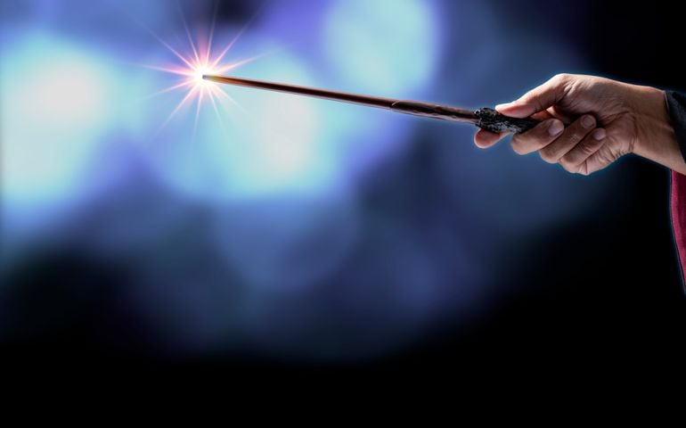 Magic wand with sparkle on blue background, Miracle magical stick Wizard tool on hot blue.