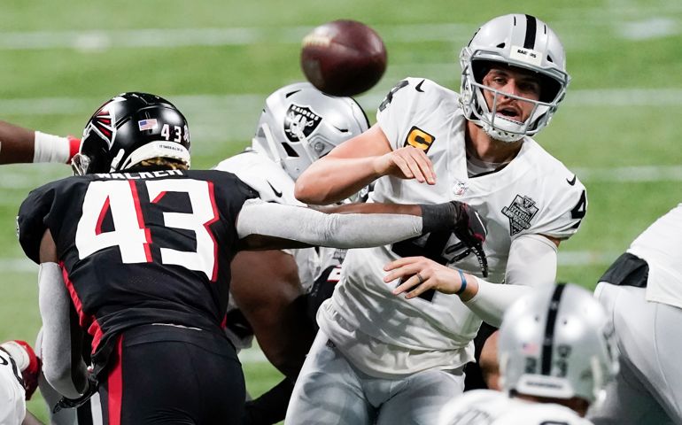 Atlanta Falcons linebacker Mykal Walker (43) hits Las Vegas Raiders quarterback Derek Carr (4) during the second half of an NFL football game, Sunday, Nov. 29, 2020, in Atlanta. Carr through an interception on the play.