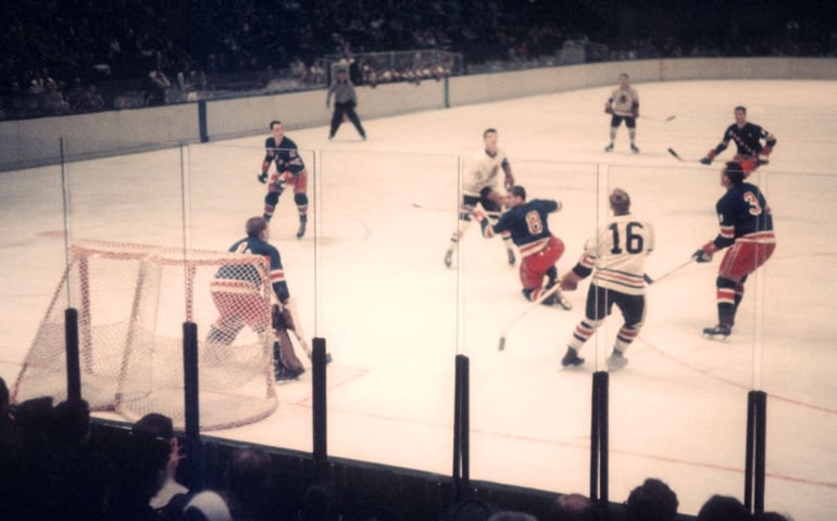 NEW YORK, NY - 1958: Goalie Gump Worsley #1, Lou Fontinato #8, Harry Howell #3 of the New York Rangers and Bobby Hull #16 of the Chicago Blackhawks look up for the puck during an NHL game circa 1958 at the Madison Square Garden in New York, New York.