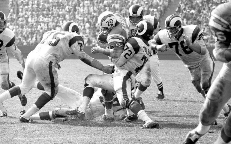 LOS ANGELES, CA - OCTOBER 4: Russ Smith #20 of the San Diego Chargers is tackled by Diron Talbert #72, Deacon Jones #75 and Clark Miller #78 of the Los Angeles Rams during an NFL game on October 4, 1970 at the Los Angeles Memorial Coliseum in Los Angeles, California. (Photo by Martin Mill