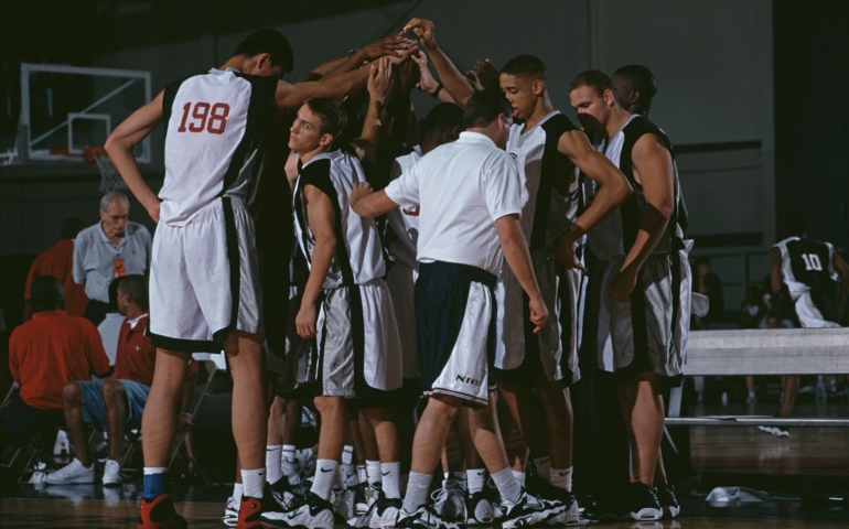 Yao Ming of China #198 playing Center at the Nike High School Basketball Camp reaches into the huddle with his team mates on 7th July 1998 at the National Institute for Fitness and Sport in Indianapolis, Indiana, United States.
