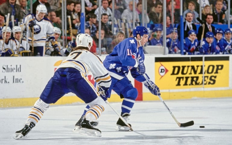 Joe Sakic #19, Captain and Center for the Quebec Nordiques in motion on the ice skates past #7 Petr Svoboda of the Buffalo Sabres during the NHL Eastern Conference Northeast Division game on 10th April 1994 at the Buffalo Memorial Auditorium in Buffalo, New York, United States. The Sabres won the game 4 - 1.