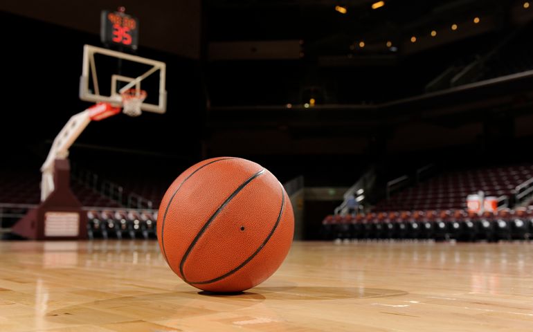 Basketball on the floor of a indoor court.