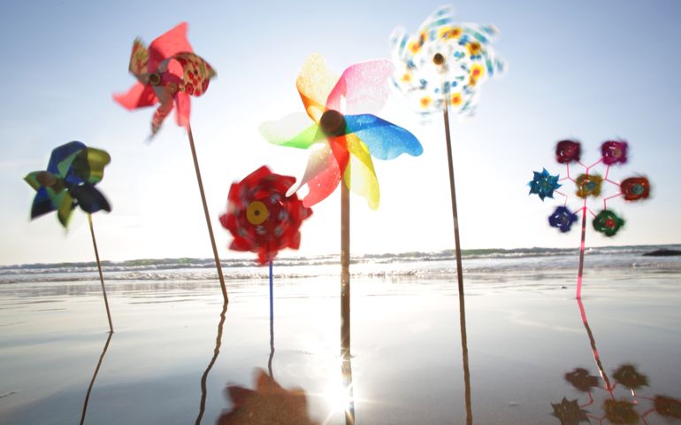 Windmills in the sand at the waters edge