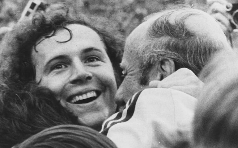West German footballer Franz Beckenbauer beams with joy as he is embraced by coach Helmut Schon, after his team beat Holland 2-1 to win the 1974 World Cup