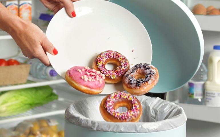Dieter throwing away donuts