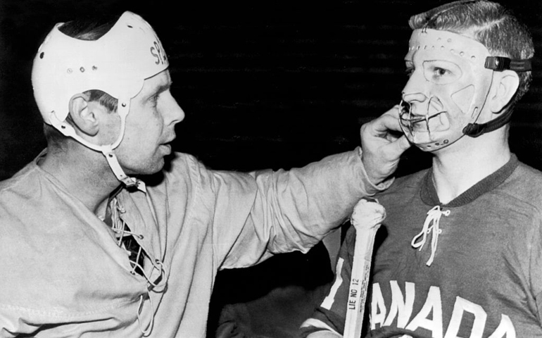 Swedish hockey goalie Yngve Johansson inspects the mask of Canadian Trail Smoke Eaters goalie, Seth Martin before playing the match, Stockholm, Sweden, February 6, 1961. The Canadian team was on a European tour before playing in the World Championships in Switzerland, where they won the world title.