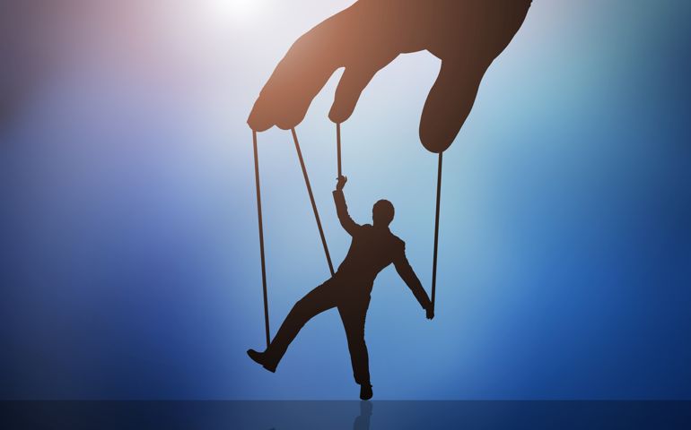 Close-up Of Businessman's Hands Saving Piggybank From Hammering