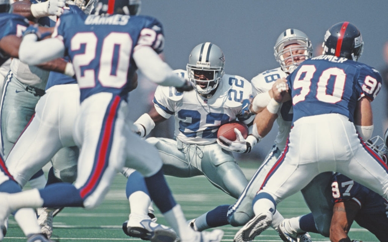 Emmitt Smith #22, Running Back for the Dallas Cowboys runs the ball through the Giants defence during the National Football Conference East game against the New York Giants on 5 October 1997 at the Giants Stadium, East Rutherford, New Jersey, United States. Giants won 17 - 20 .