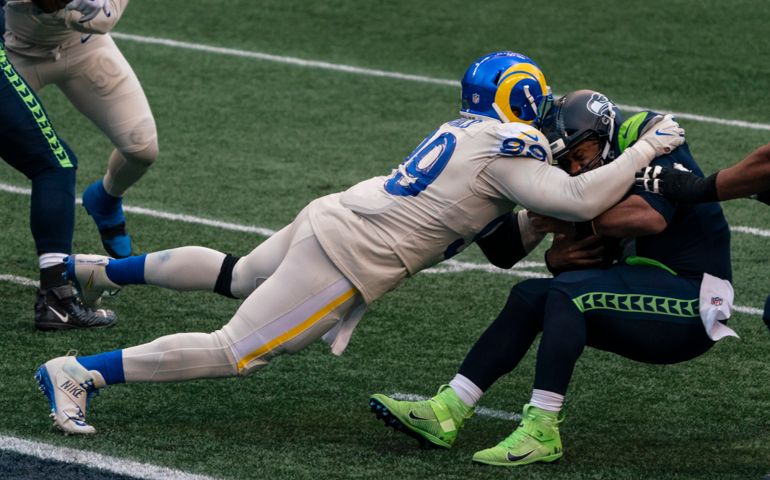 Los Angeles Rams defensive lineman Aaron Donald sacks Seattle Seahawks quarterback Russell Wilson during the second half of an NFL football game, Sunday, Dec. 27, 2020, in Seattle. The Seahawks won 20-9