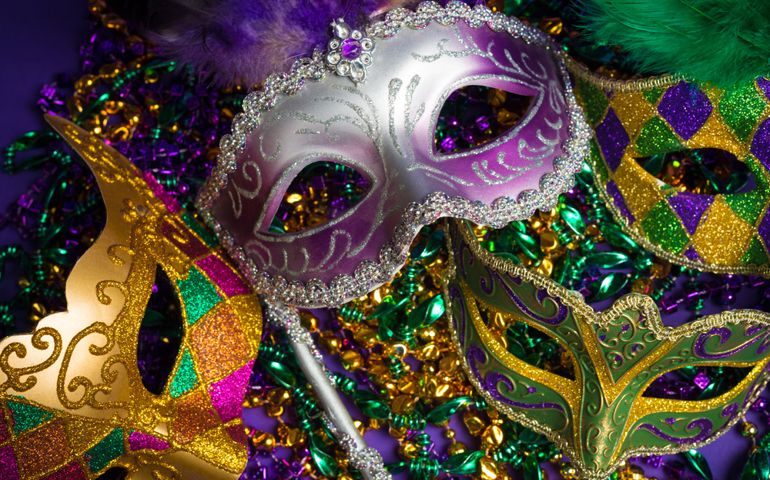 Festive Grouping of mardi gras, venetian or carnivale mask on a purple background