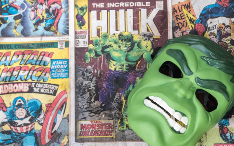 Hulk mask laying on top of vintage comic books